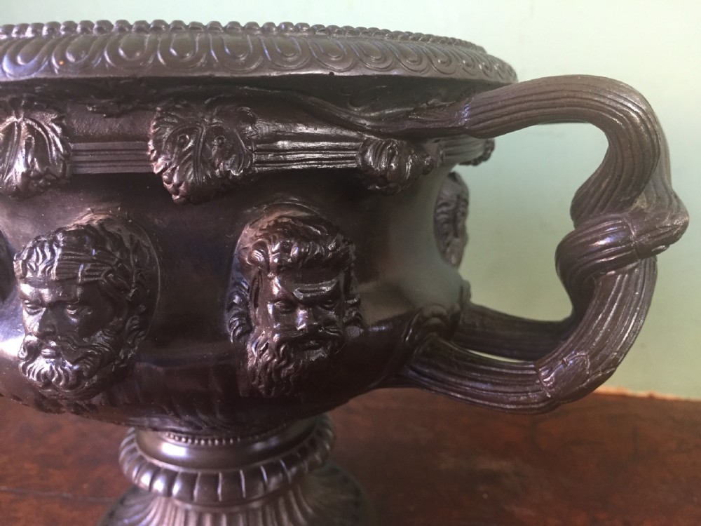 A nineteenth-century dark bronze reduction of the Albani Vase featuring classical sculpted masks along the body, intertwined handles, and a pedestal base. View XI