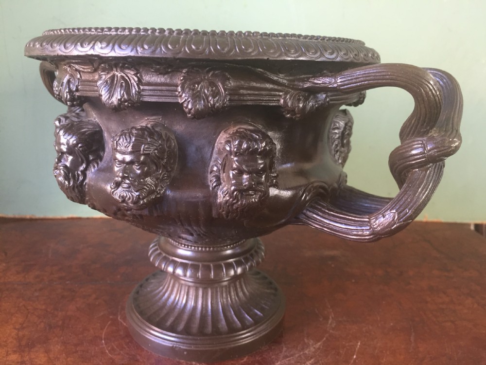 A nineteenth-century dark bronze reduction of the Albani Vase featuring classical sculpted masks along the body, intertwined handles, and a pedestal base. View XIV