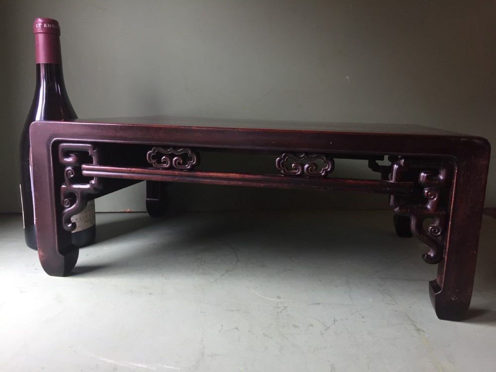 A late 19th-century Chinese dark hongmu hardwood scholars low table featuring carved cloud motif spandrels and straight legs. View III