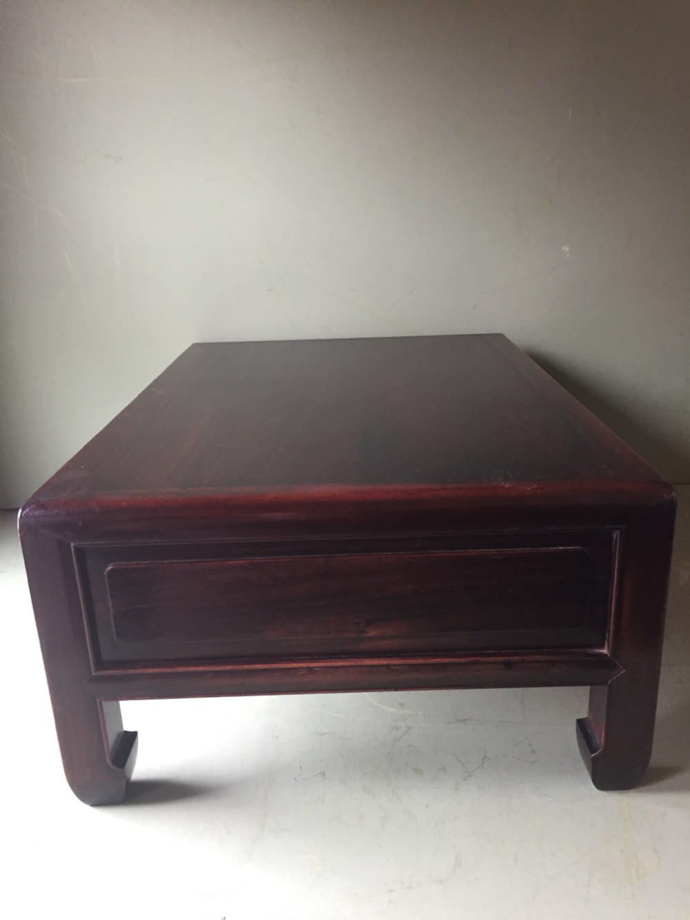 A late 19th-century Chinese dark hongmu hardwood scholars low table featuring carved cloud motif spandrels and straight legs. View VI