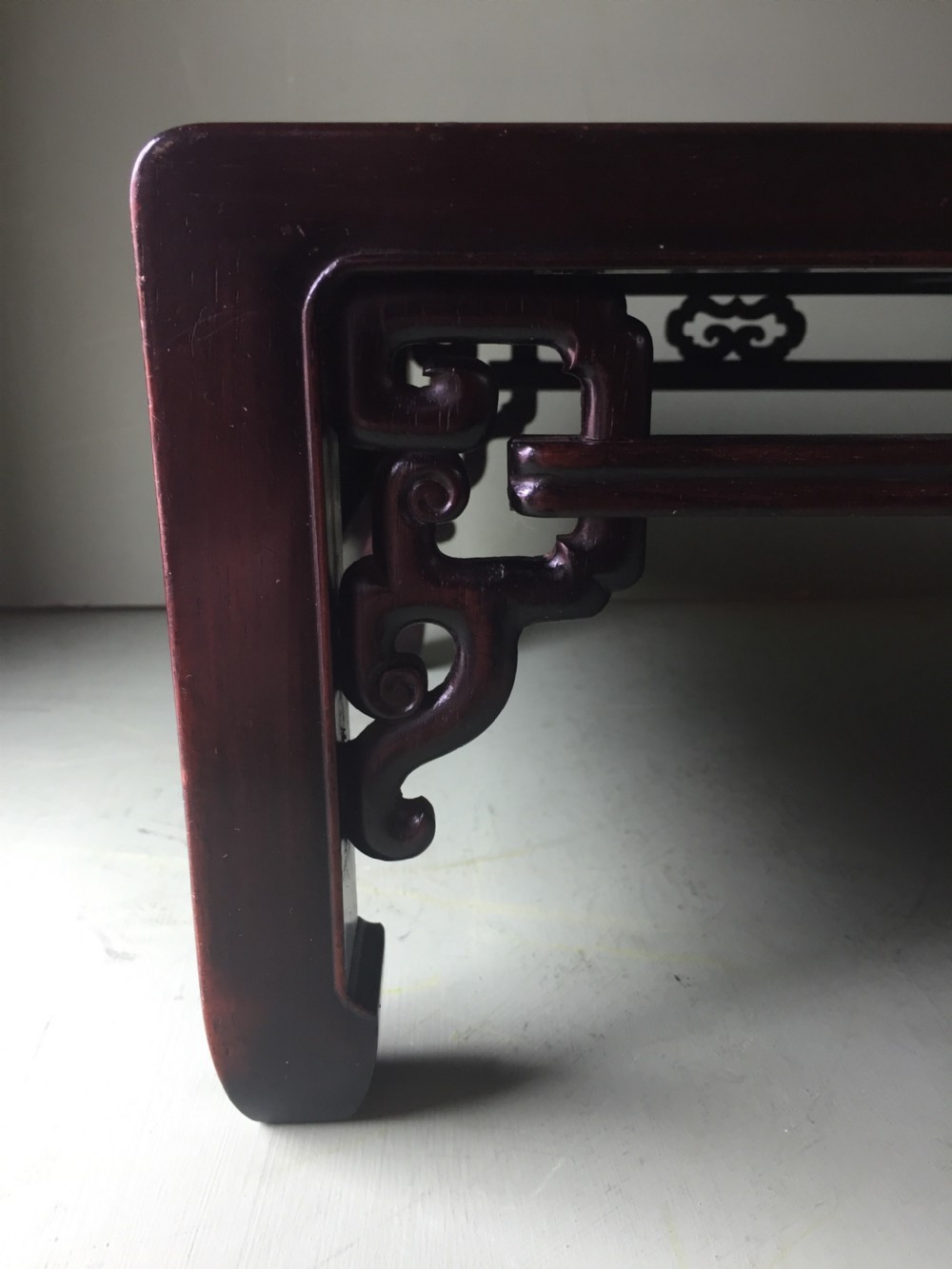 A late 19th-century Chinese dark hongmu hardwood scholars low table featuring carved cloud motif spandrels and straight legs. View VIII