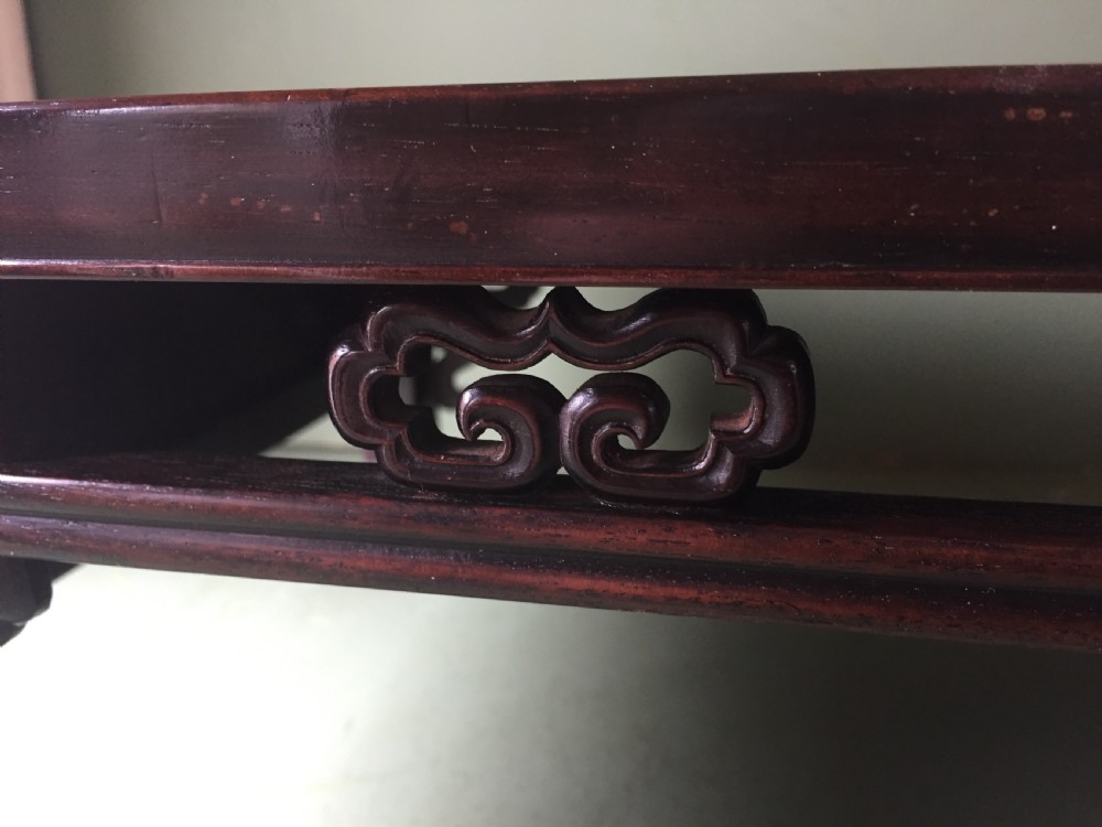 A late 19th-century Chinese dark hongmu hardwood scholars low table featuring carved cloud motif spandrels and straight legs. View IX