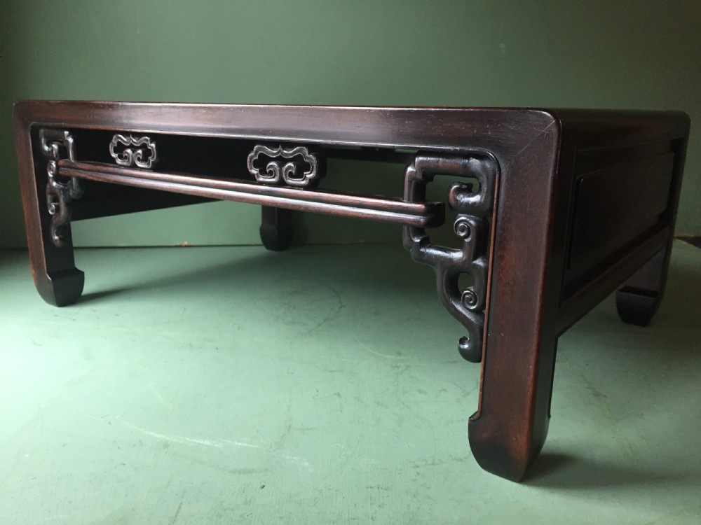A late 19th-century Chinese dark hongmu hardwood scholars low table featuring carved cloud motif spandrels and straight legs. View XI