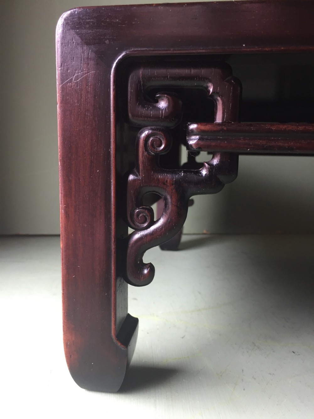 A late 19th-century Chinese dark hongmu hardwood scholars low table featuring carved cloud motif spandrels and straight legs. View XIII