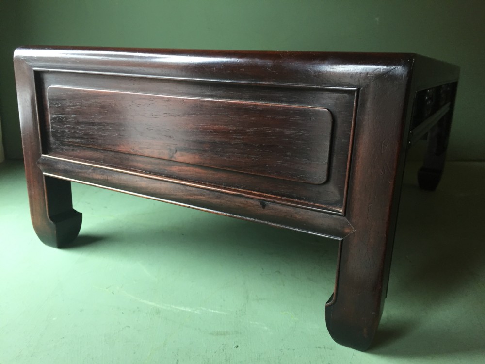 A late 19th-century Chinese dark hongmu hardwood scholars low table featuring carved cloud motif spandrels and straight legs. View XVI