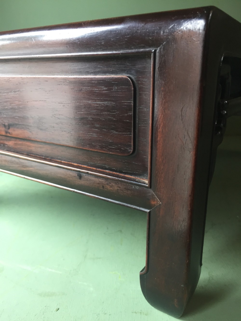 A late 19th-century Chinese dark hongmu hardwood scholars low table featuring carved cloud motif spandrels and straight legs. View XVII
