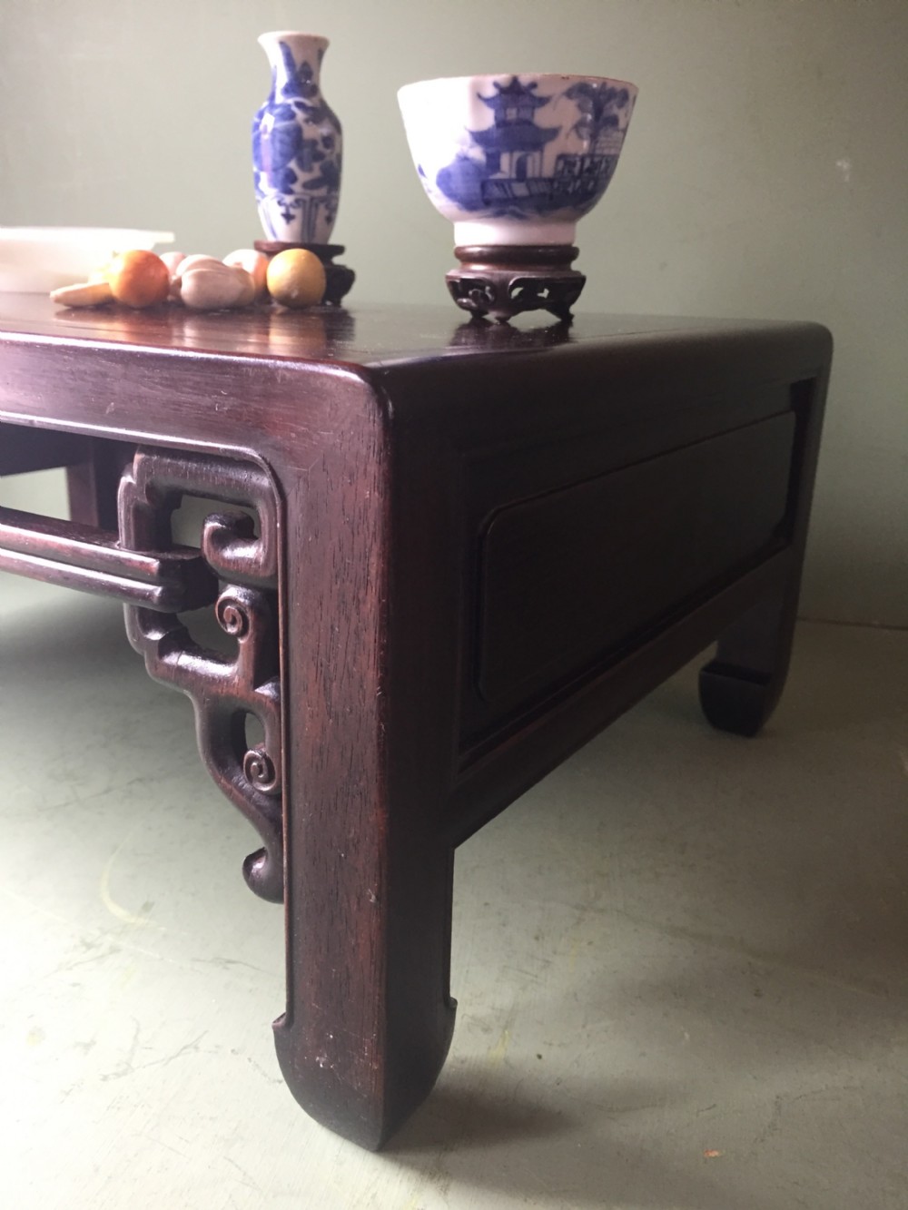 A late 19th-century Chinese dark hongmu hardwood scholars low table featuring carved cloud motif spandrels and straight legs. View XXI