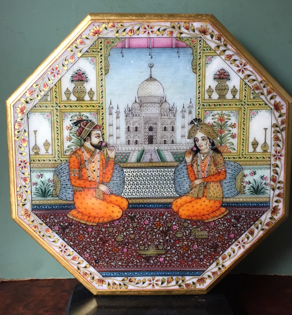 Finely painted early C20th Indian octagonal marble panel depicting Shah Jahan and Mumtaz Mahal , posed on a carpet before the Taj Mahal in Agra.