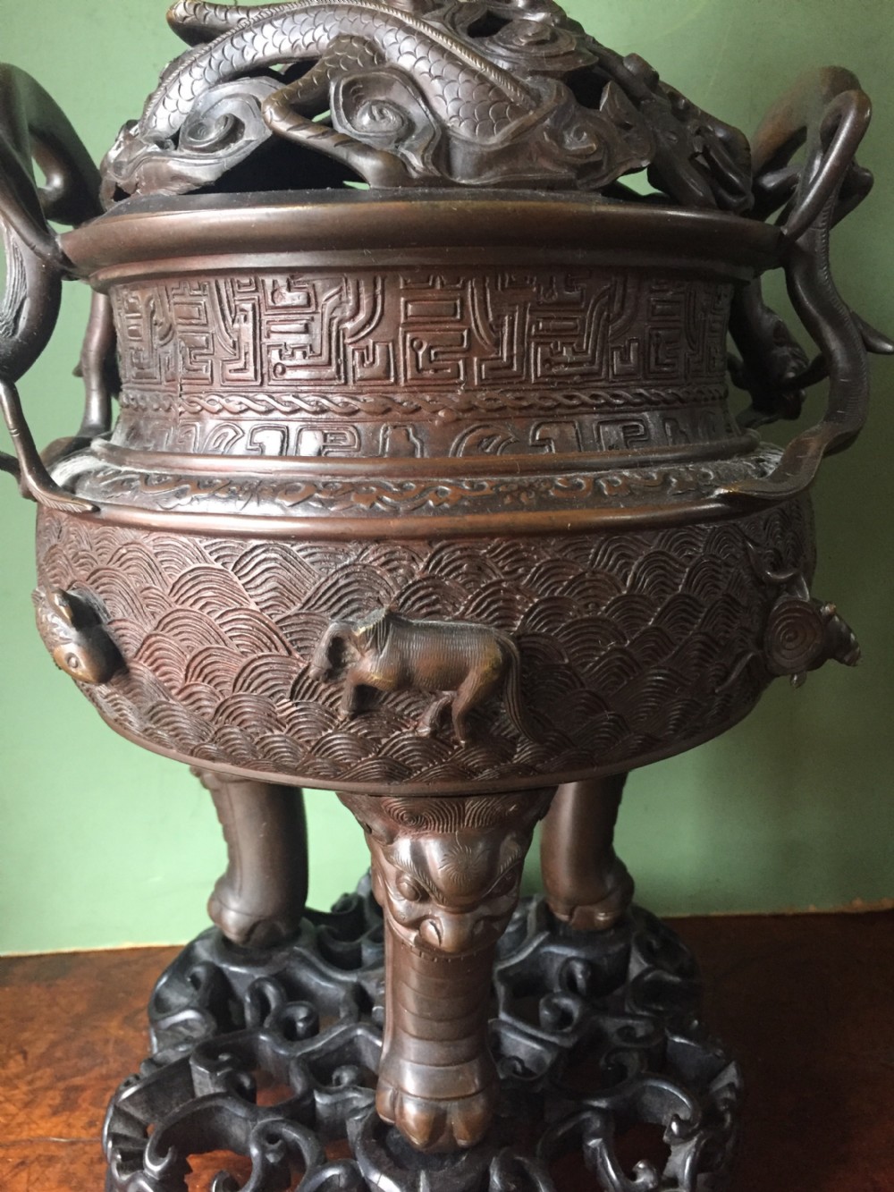 C19th Chinese Qing Dynasty cast bronze 'dragon' censer , or incense burner , and cover on original carved hardwood stand . View XXI