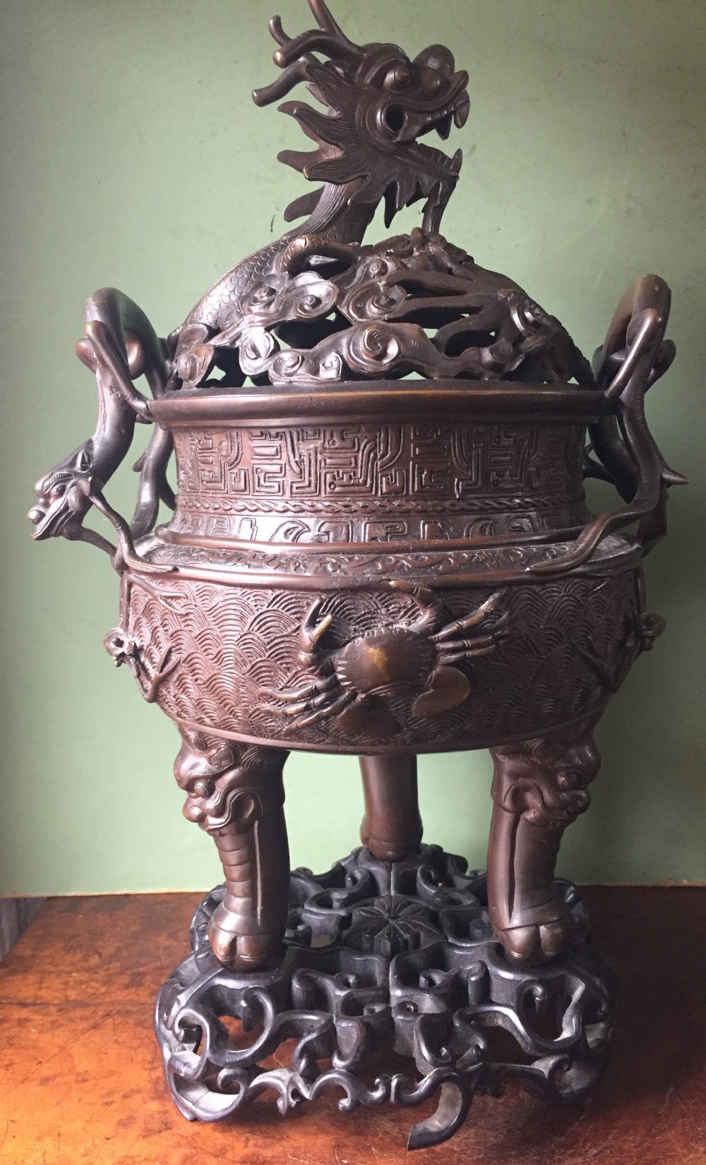 C19th Chinese Qing Dynasty cast bronze 'dragon' censer , or incense burner , and cover on original carved hardwood stand .