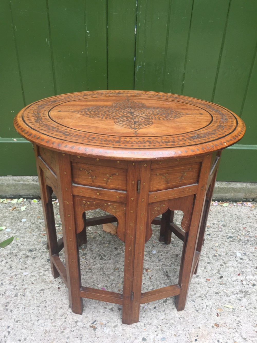 Late C19th Indian brass-inlaid oval teak occasional table on folding arcaded base. View II