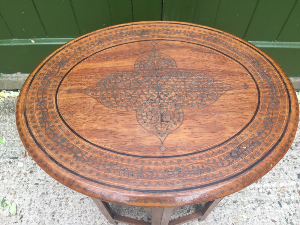Late C19th Indian brass-inlaid oval teak occasional table on folding arcaded base. View III