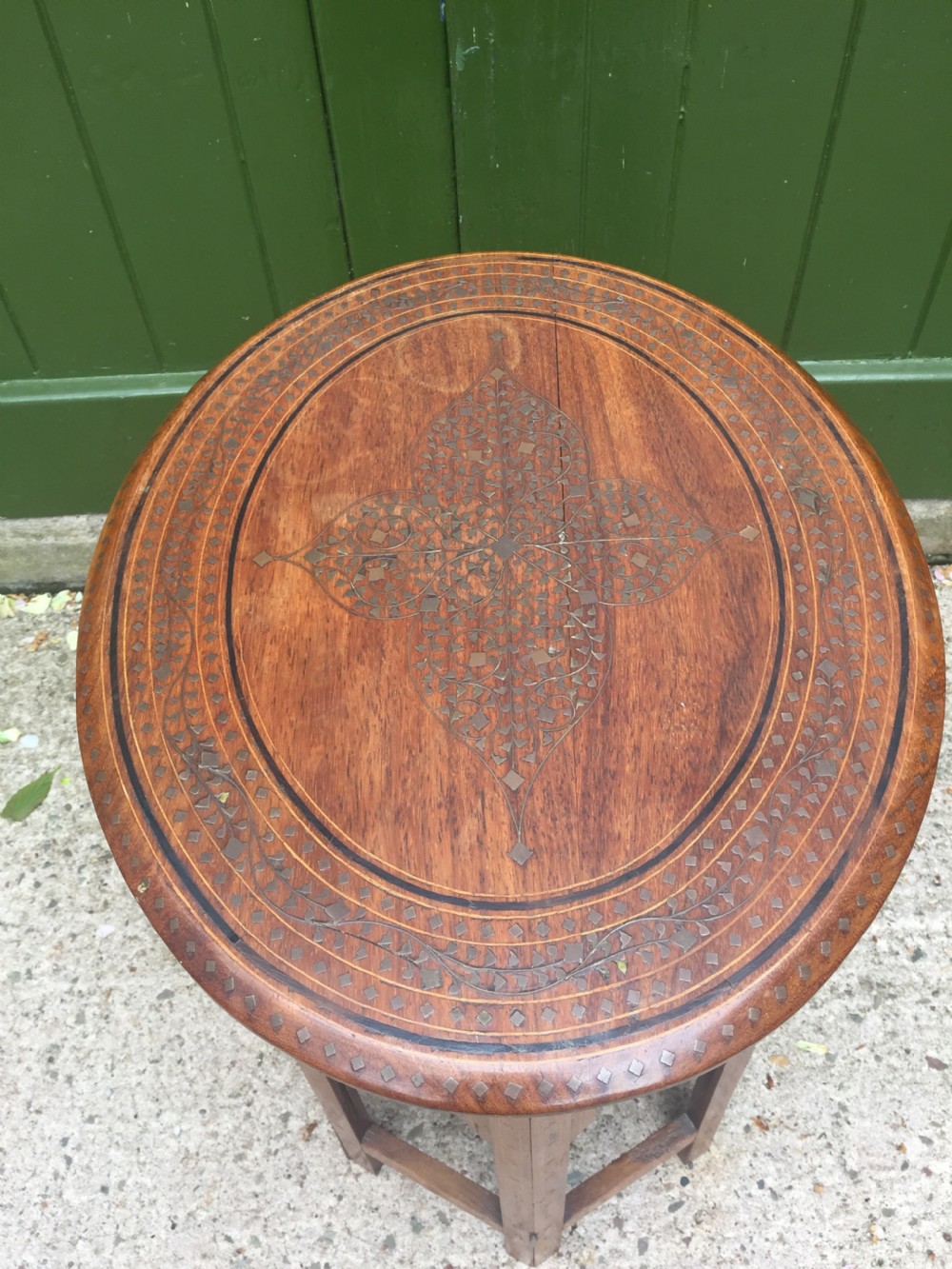 Late C19th Indian brass-inlaid oval teak occasional table on folding arcaded base. View IV