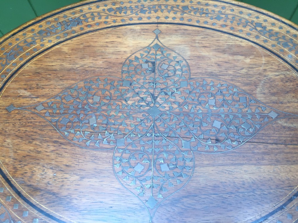 Late C19th Indian brass-inlaid oval teak occasional table on folding arcaded base. View VIII
