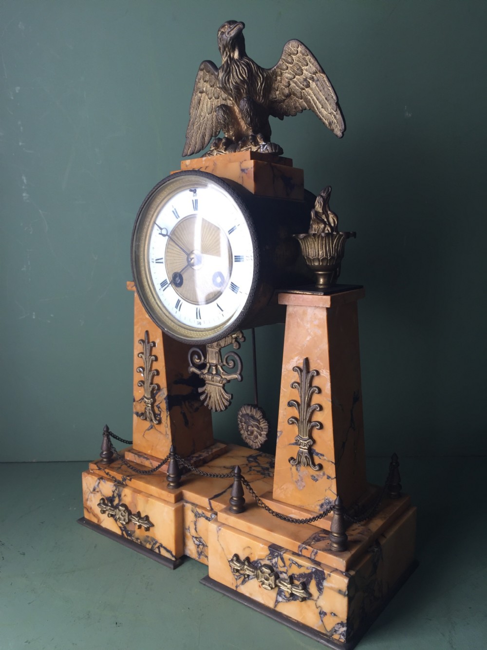 A late nineteenth-century French Empire style clock garniture crafted from yellow Siena marble and gilt ormolu, featuring a central clock topped with an eagle and flanked by two candelabra. View IX