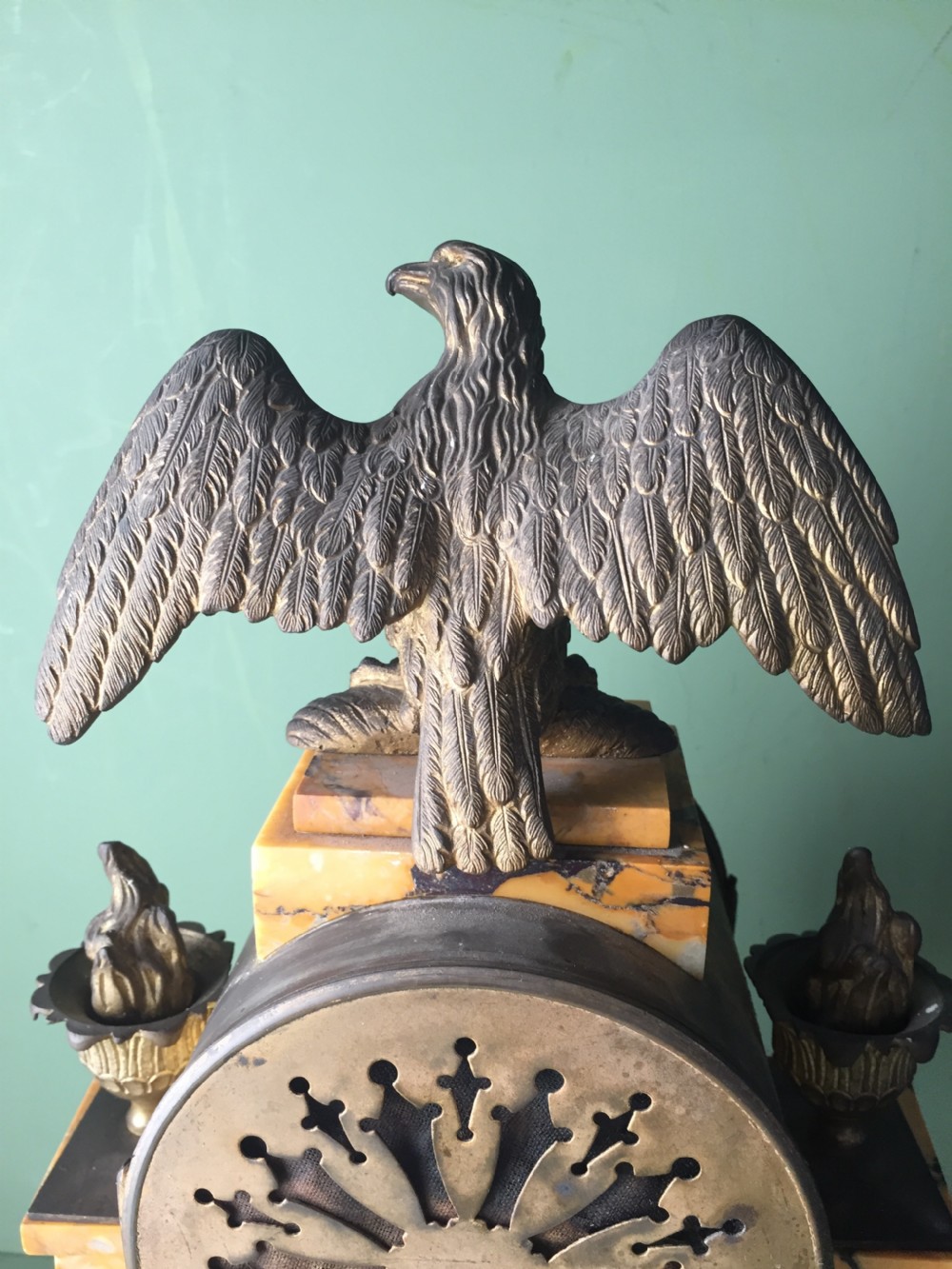 A late nineteenth-century French Empire style clock garniture crafted from yellow Siena marble and gilt ormolu, featuring a central clock topped with an eagle and flanked by two candelabra. View XIII