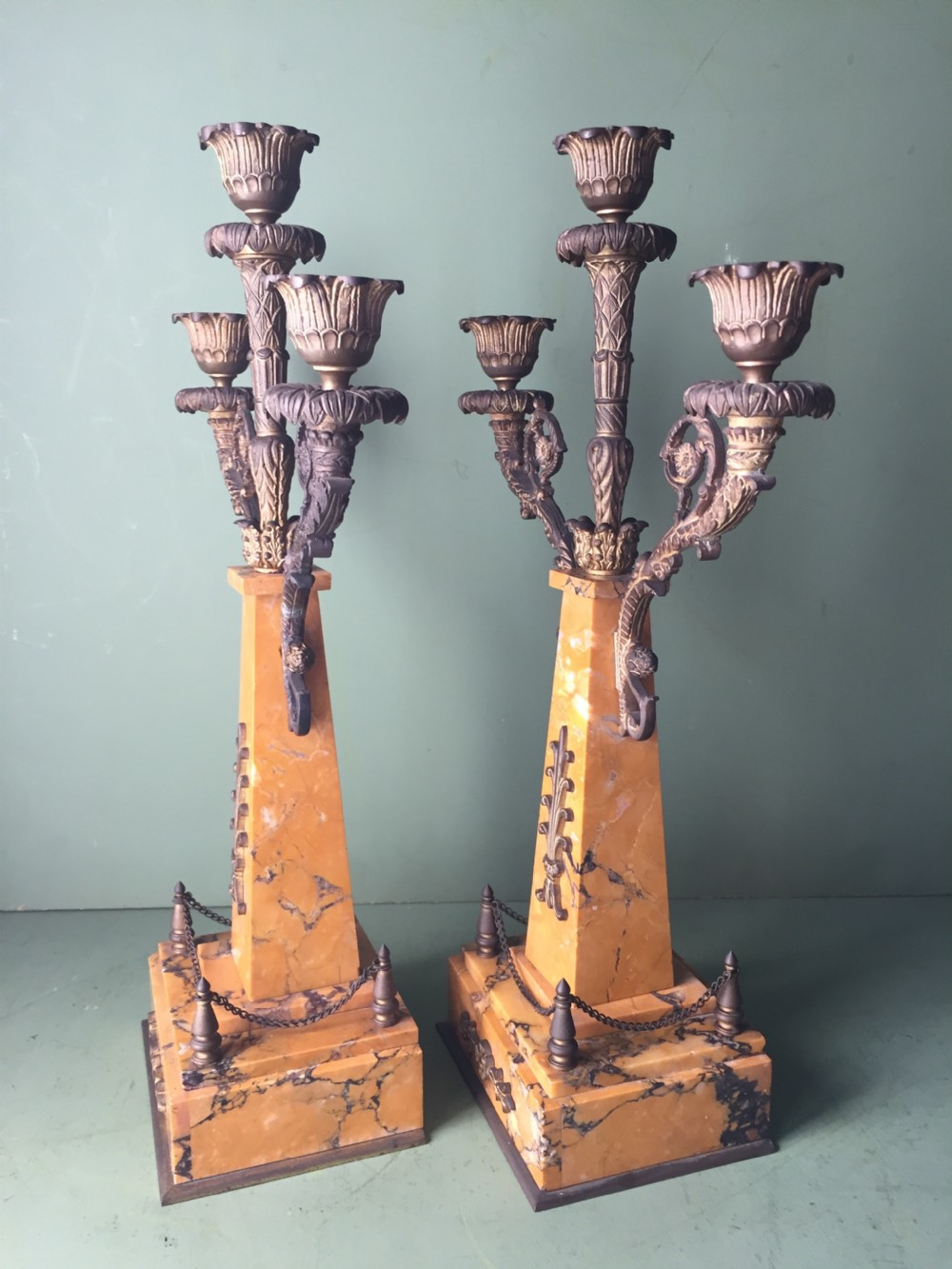 A late nineteenth-century French Empire style clock garniture crafted from yellow Siena marble and gilt ormolu, featuring a central clock topped with an eagle and flanked by two candelabra. View XVI