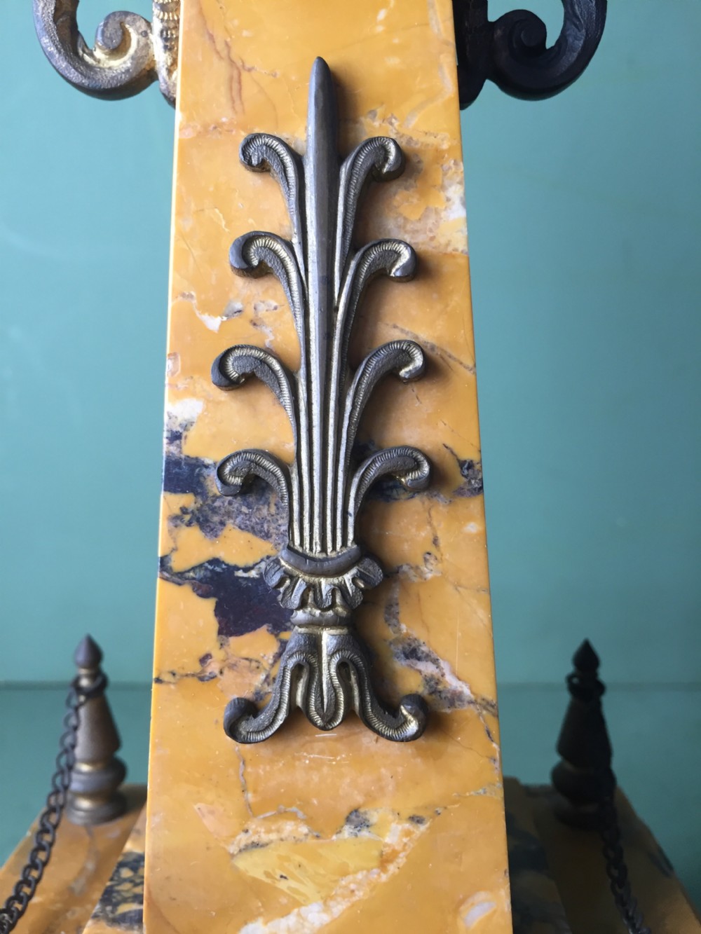 A late nineteenth-century French Empire style clock garniture crafted from yellow Siena marble and gilt ormolu, featuring a central clock topped with an eagle and flanked by two candelabra. View XVII