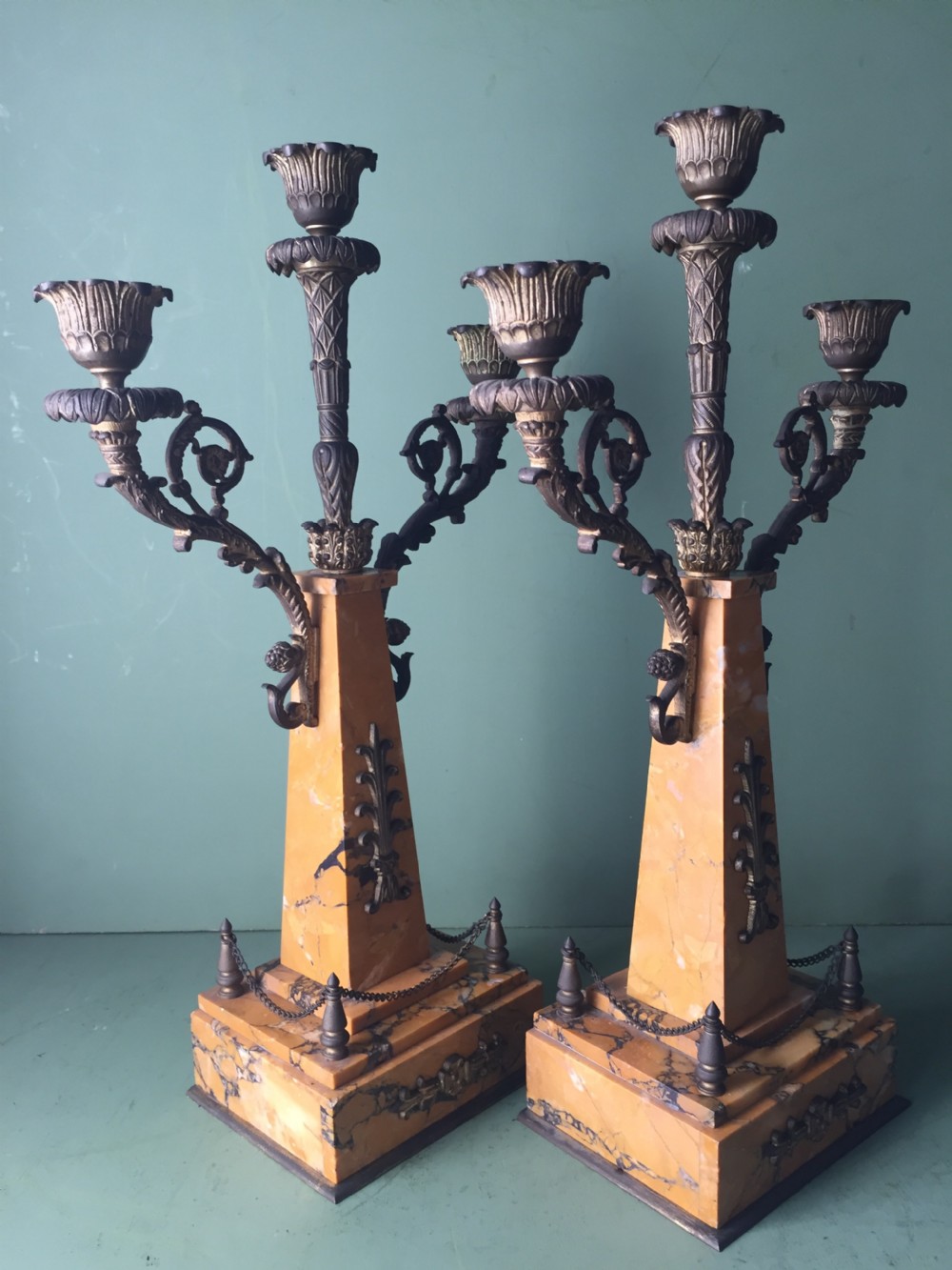 A late nineteenth-century French Empire style clock garniture crafted from yellow Siena marble and gilt ormolu, featuring a central clock topped with an eagle and flanked by two candelabra. View XXI