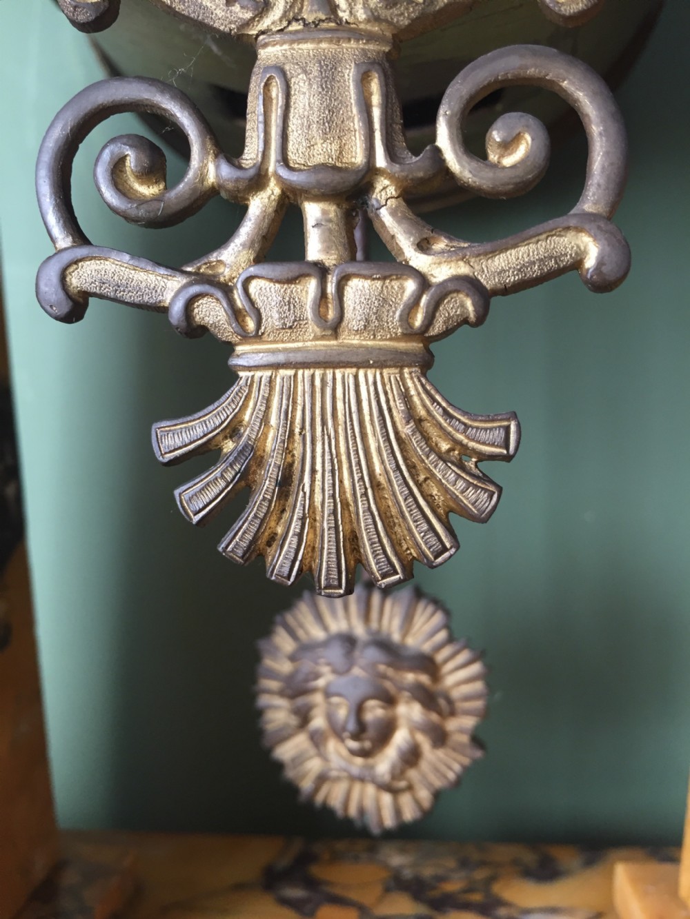 A late nineteenth-century French Empire style clock garniture crafted from yellow Siena marble and gilt ormolu, featuring a central clock topped with an eagle and flanked by two candelabra. View XXVII