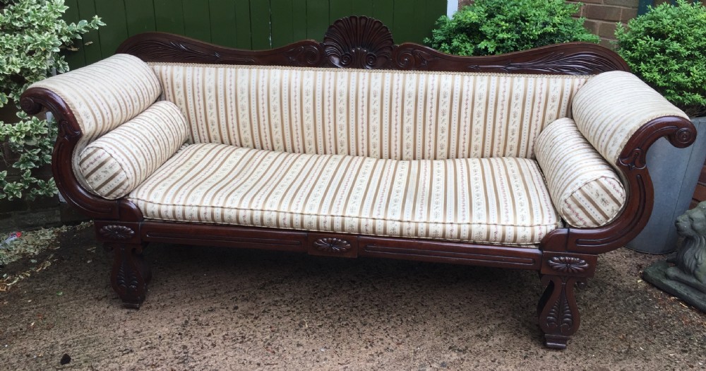 Early C19th Regency period mahogany scroll-end double-ended sofa of classically inspired design.