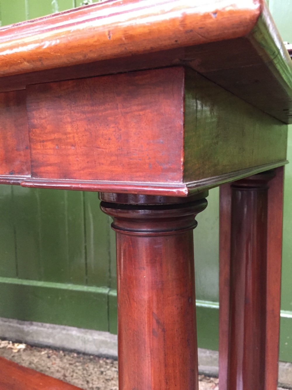 A William IV mahogany hall console table with cylindrical column supports, a raised rear gallery, and a lower plinth shelf. View VIII