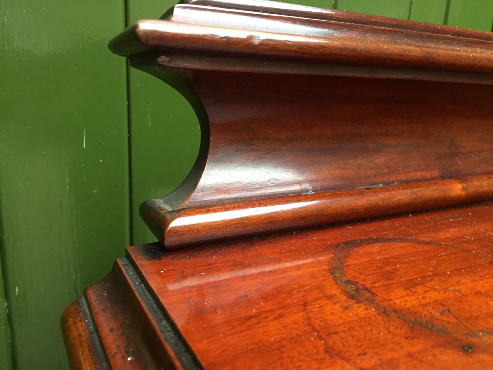 A William IV mahogany hall console table with cylindrical column supports, a raised rear gallery, and a lower plinth shelf. View XI