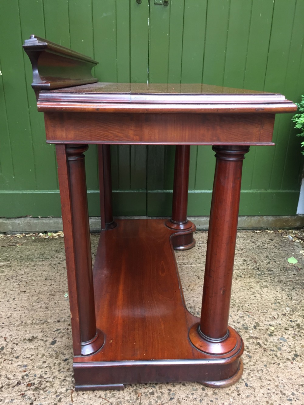 A William IV mahogany hall console table with cylindrical column supports, a raised rear gallery, and a lower plinth shelf. View XIII