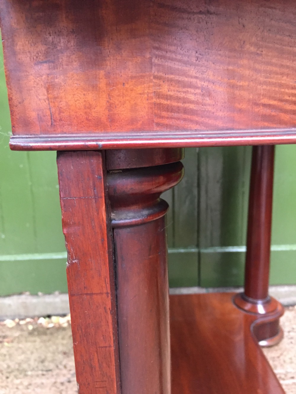 A William IV mahogany hall console table with cylindrical column supports, a raised rear gallery, and a lower plinth shelf. View XIV