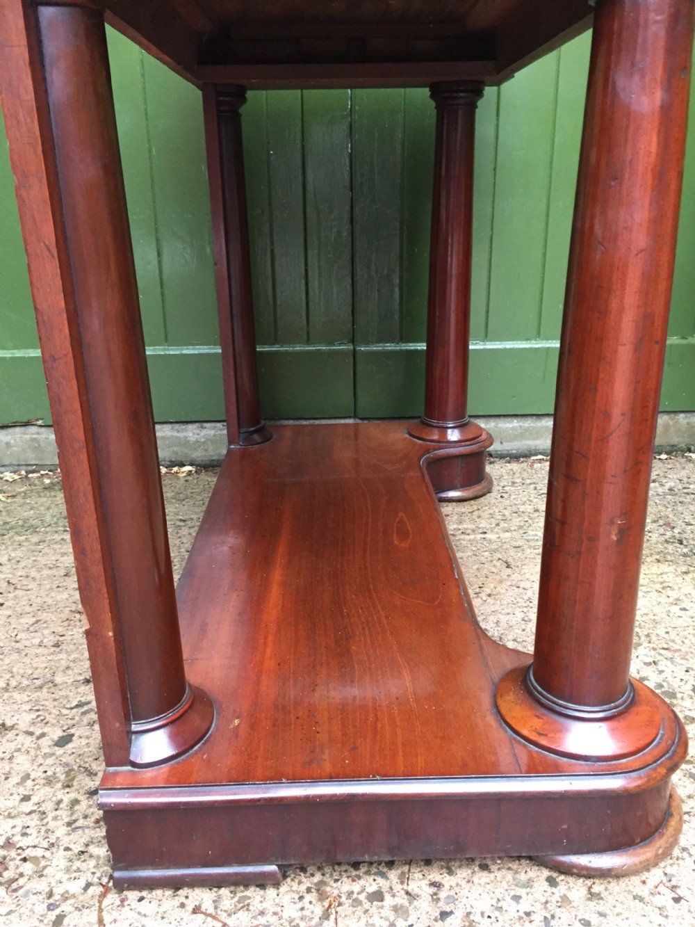 A William IV mahogany hall console table with cylindrical column supports, a raised rear gallery, and a lower plinth shelf. View XV