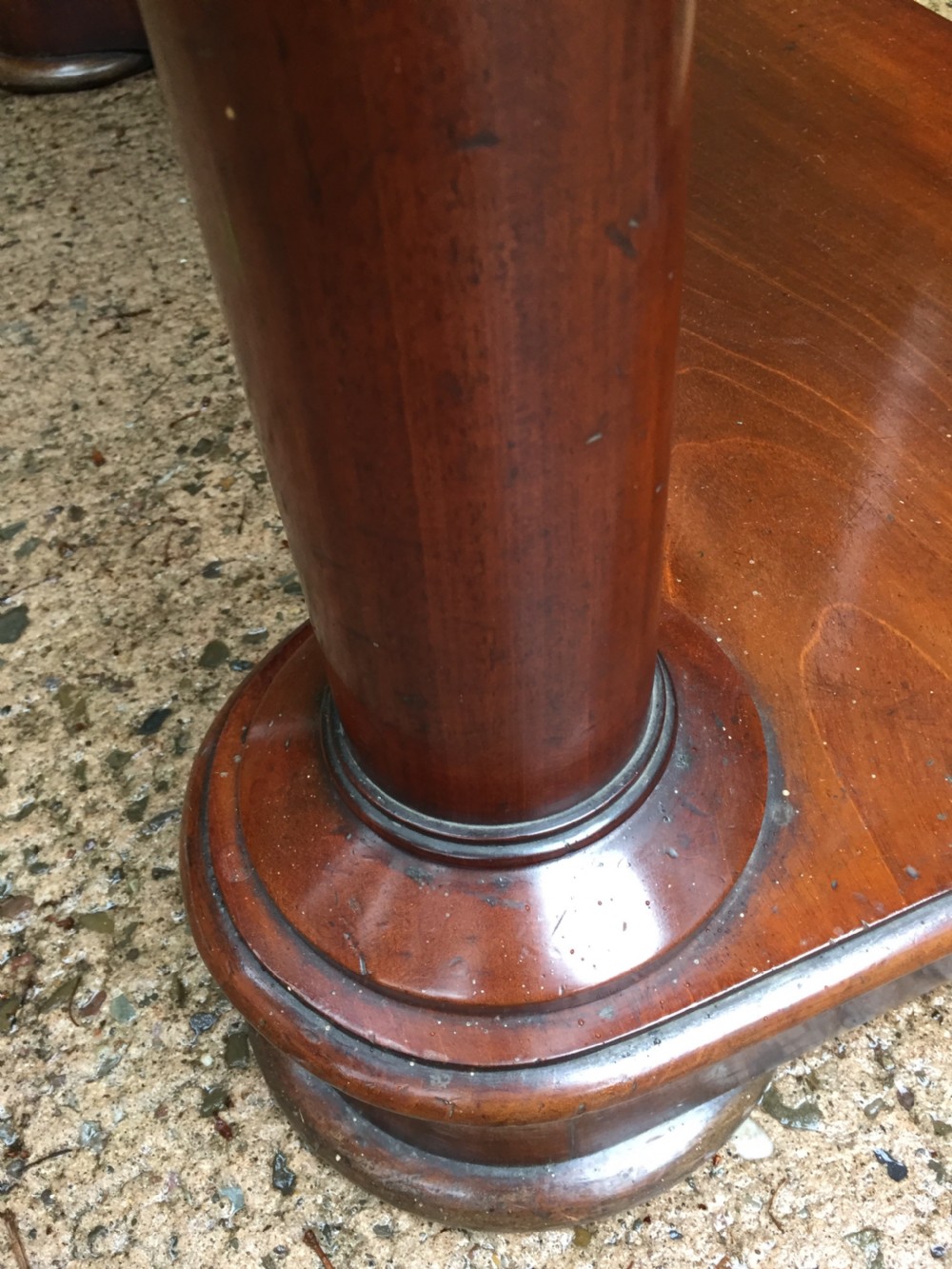 A William IV mahogany hall console table with cylindrical column supports, a raised rear gallery, and a lower plinth shelf. View XVIII