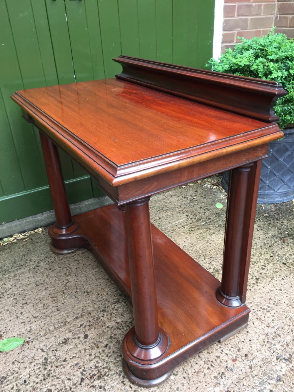 A William IV mahogany hall console table with cylindrical column supports, a raised rear gallery, and a lower plinth shelf. View XIX