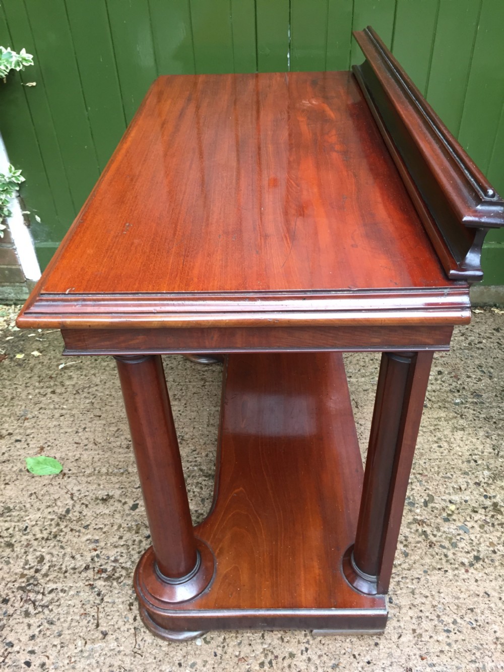 A William IV mahogany hall console table with cylindrical column supports, a raised rear gallery, and a lower plinth shelf. View XXI