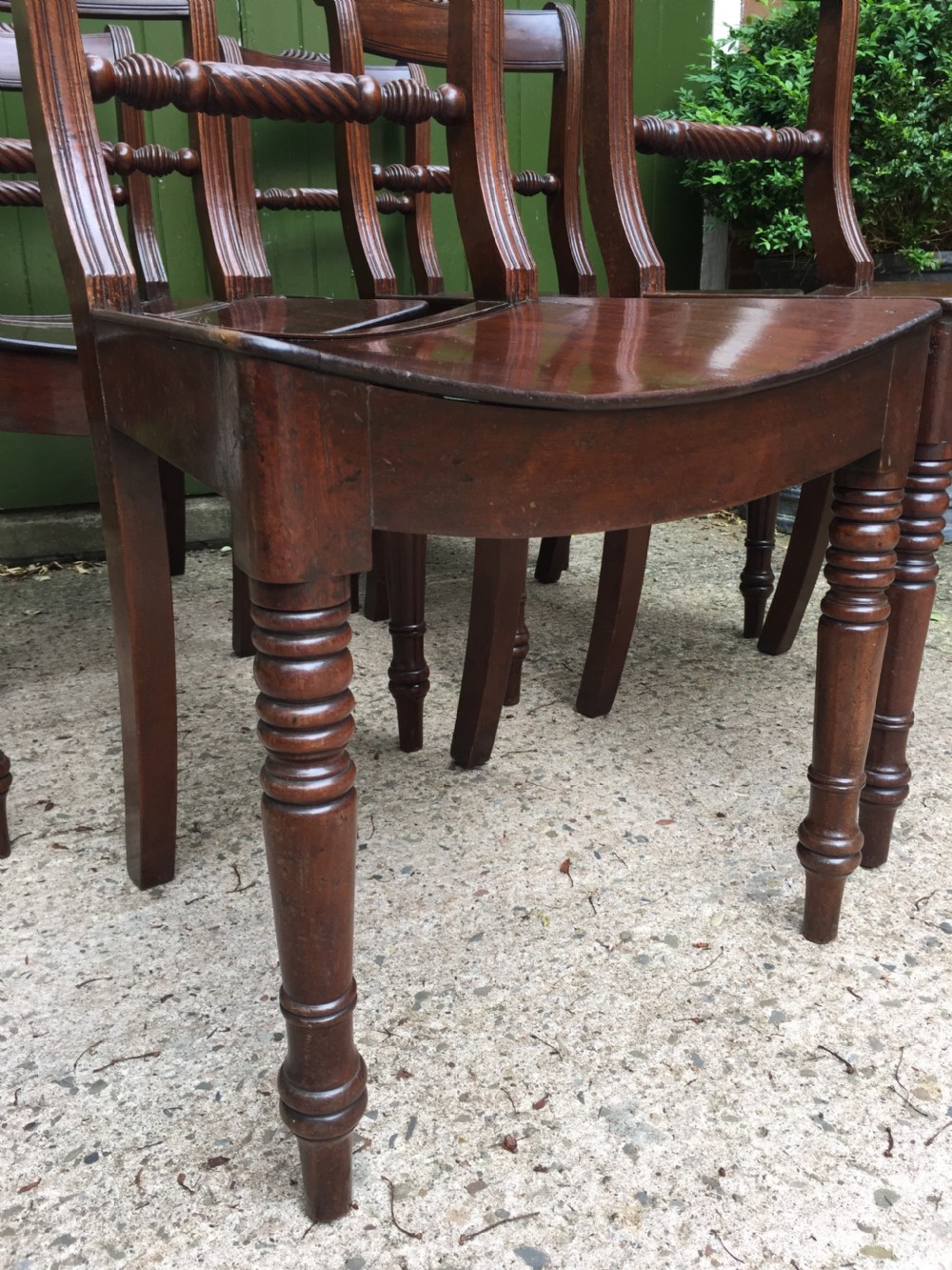 A set of six early nineteenth-century mahogany dining chairs featuring carved top rails, rope twist splats, solid wooden seats, and turned front legs. View XVII