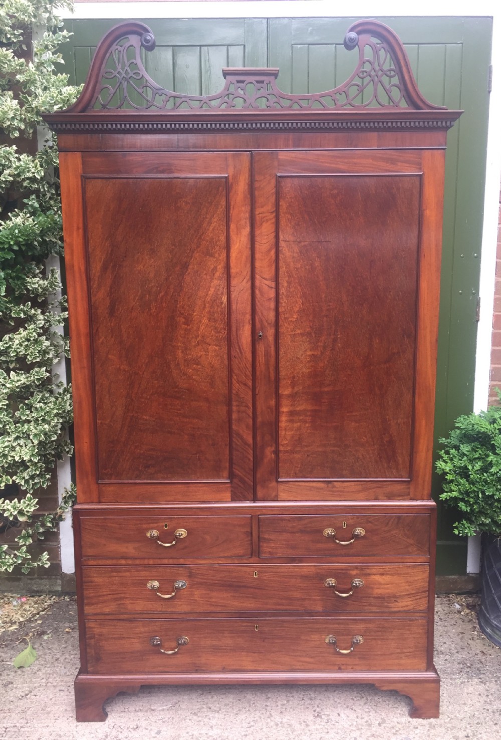 Rare George III Chippendale period and design padouk and mahogany linen-press or wardrobe with open fret-work 