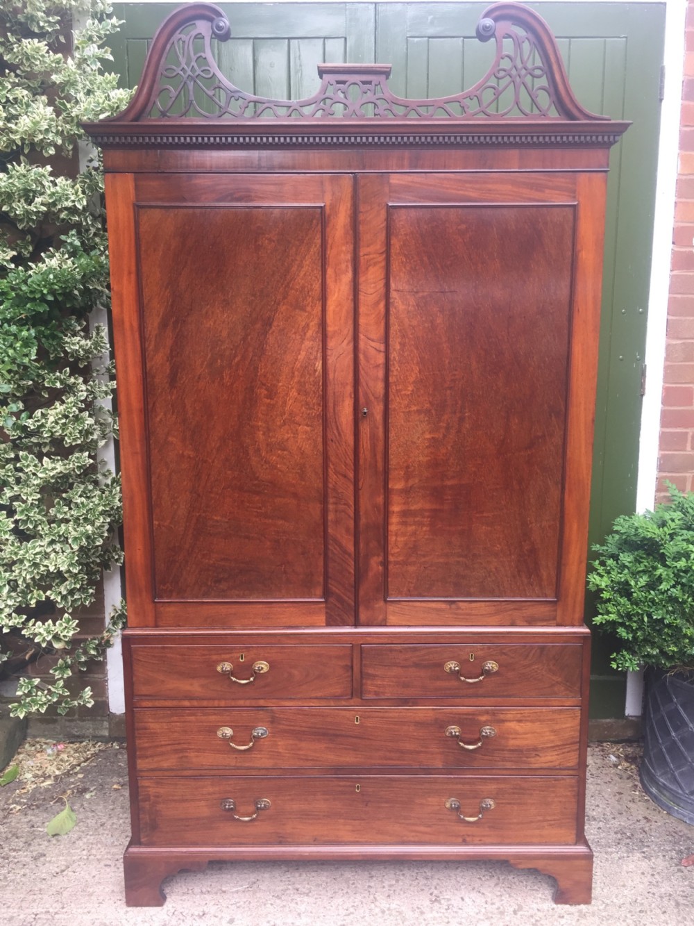 Rare George III Chippendale period and design padouk and mahogany linen-press or wardrobe with open fret-work 