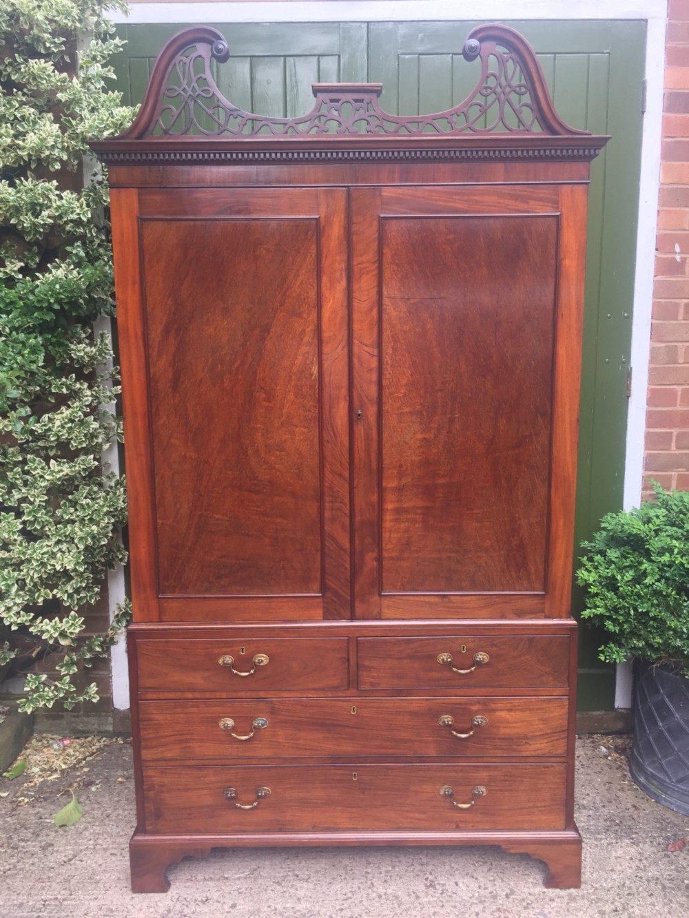 Rare George III Chippendale period and design padouk and mahogany linen-press or wardrobe with open fret-work 