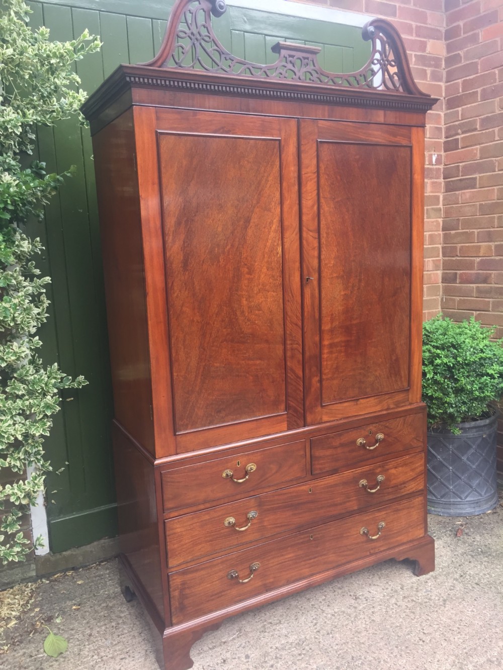Rare George III Chippendale period and design padouk and mahogany linen-press or wardrobe with open fret-work 