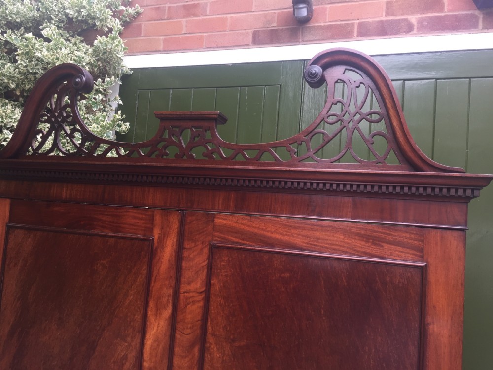 Rare George III Chippendale period and design padouk and mahogany linen-press or wardrobe with open fret-work 
