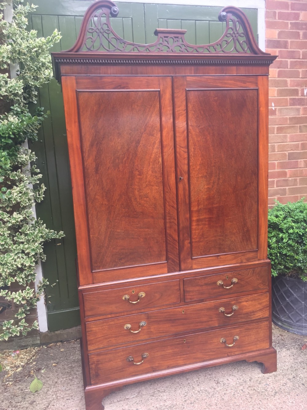 Rare George III Chippendale period and design padouk and mahogany linen-press or wardrobe with open fret-work 