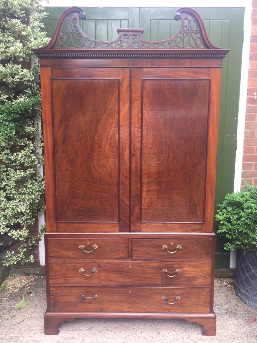 Rare George III Chippendale period and design padouk and mahogany linen-press or wardrobe with open fret-work 