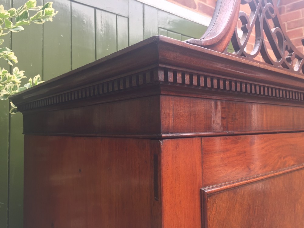 Rare George III Chippendale period and design padouk and mahogany linen-press or wardrobe with open fret-work 