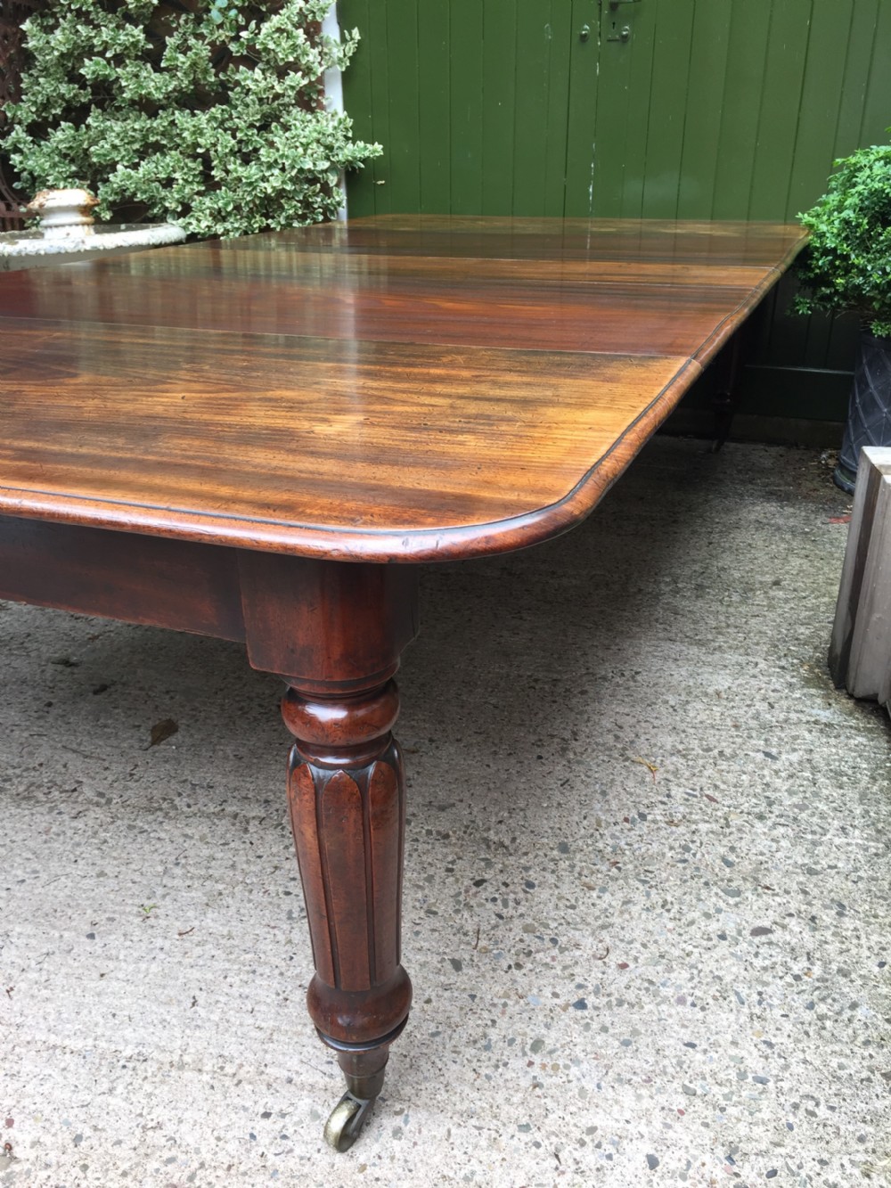 Early C19th Regency period mahogany extending dining table with 3 original additional leaves . View IV