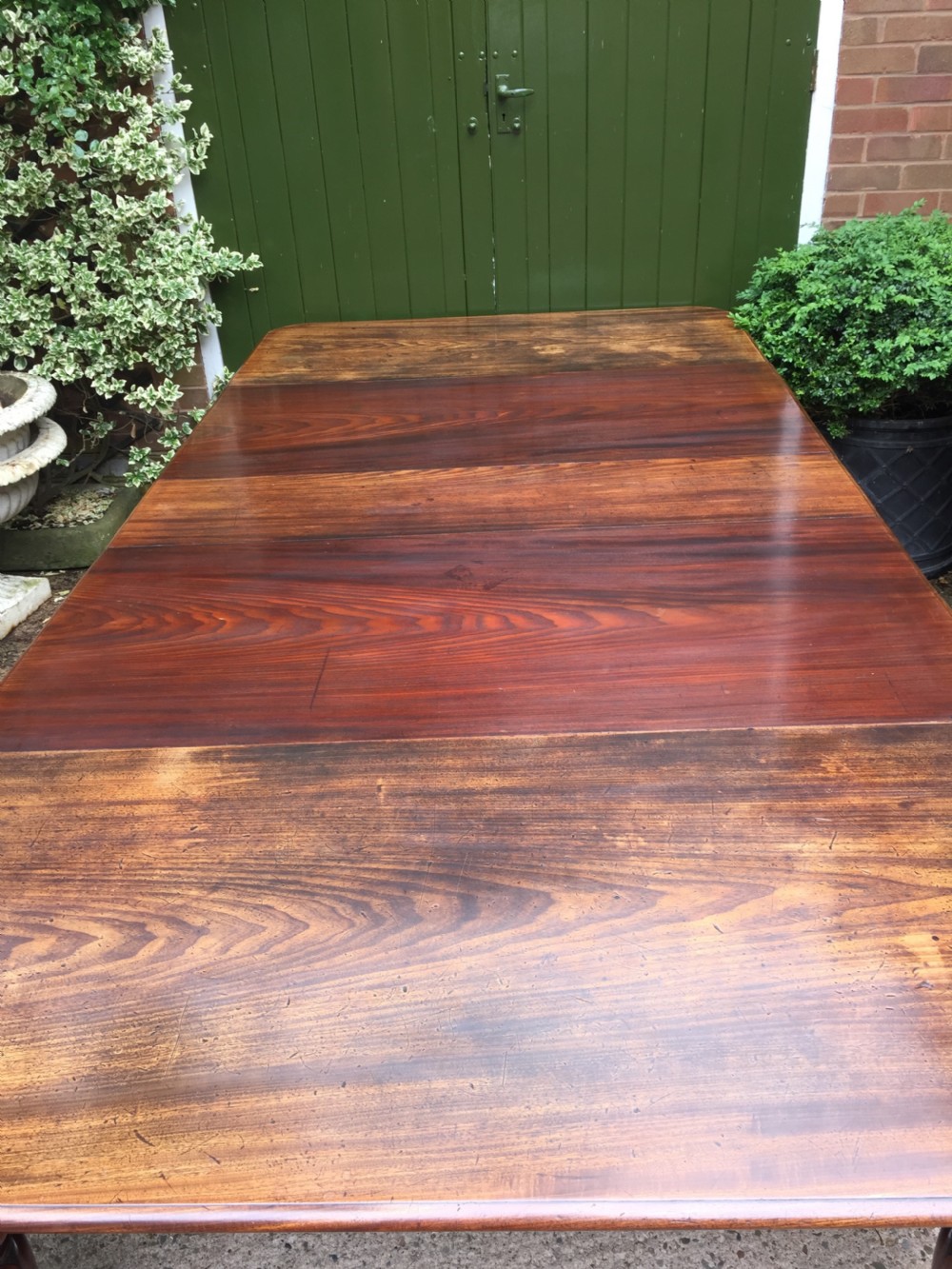 Early C19th Regency period mahogany extending dining table with 3 original additional leaves . View V