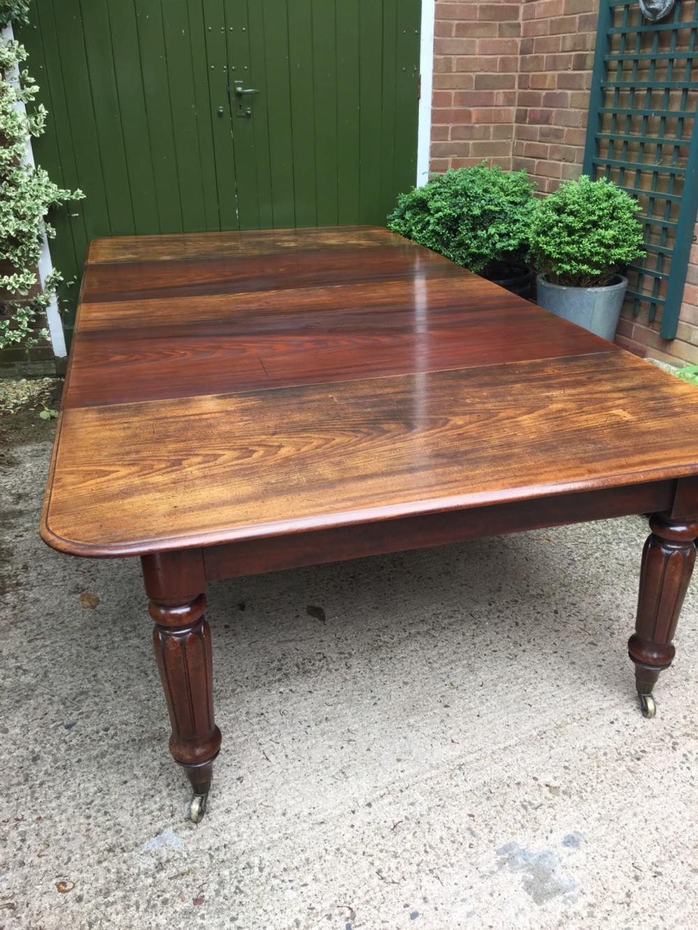 Early C19th Regency period mahogany extending dining table with 3 original additional leaves . View VIII
