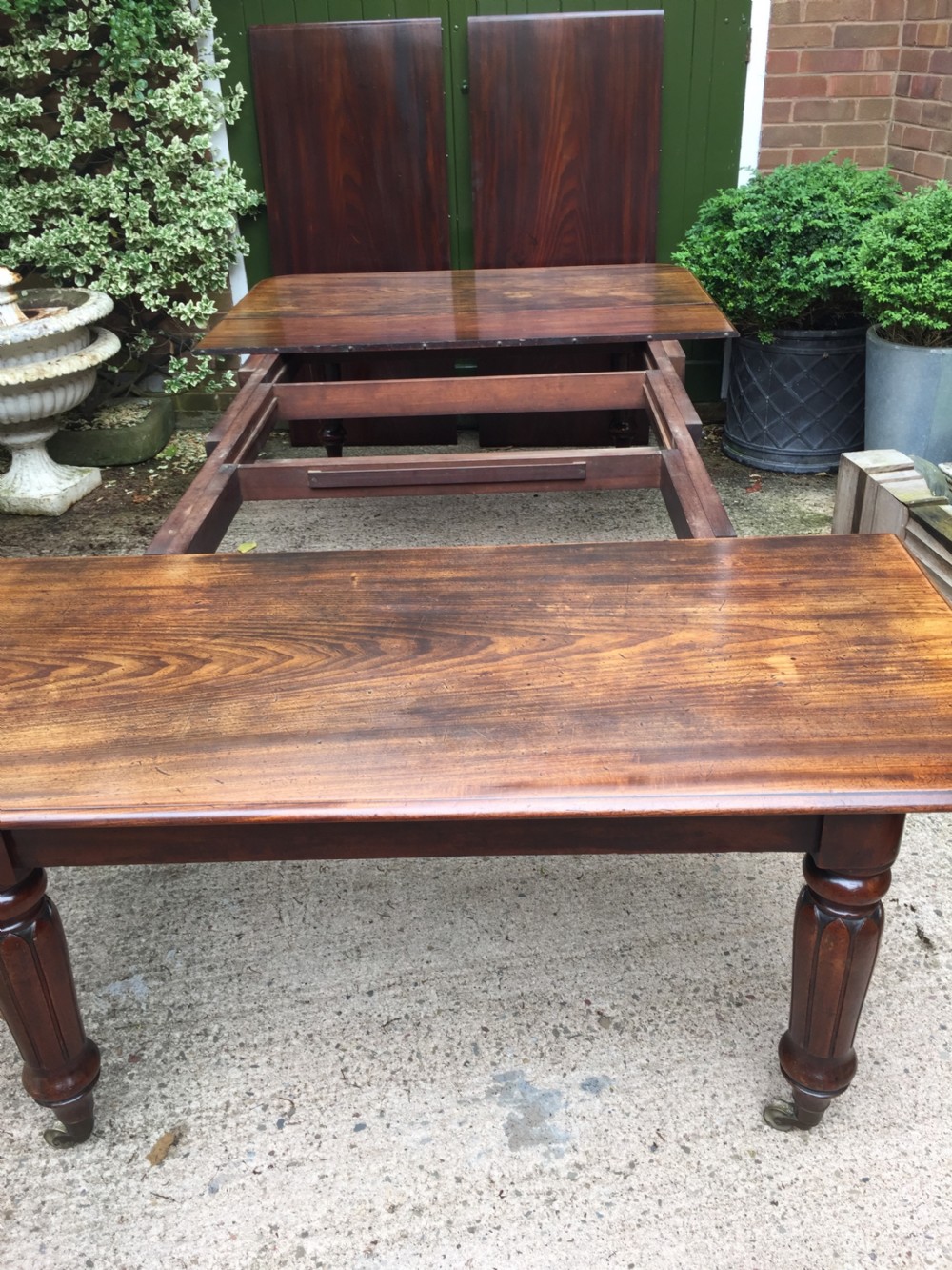 Early C19th Regency period mahogany extending dining table with 3 original additional leaves . View X