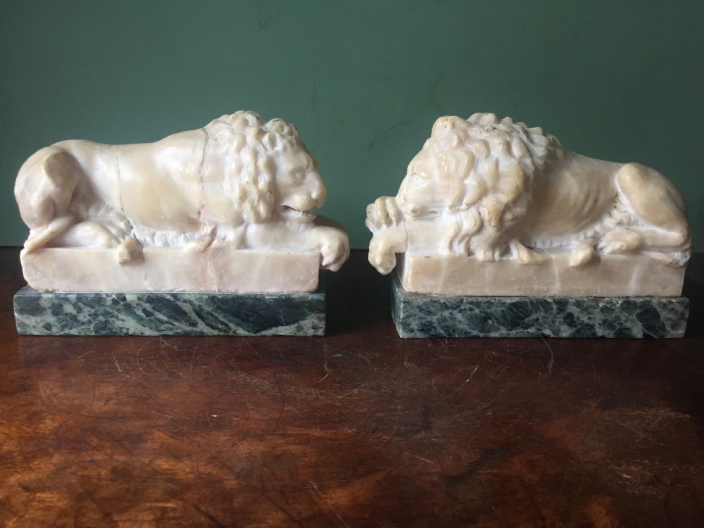 Pair of C19th Italian carved alabaster 'Grand Tour' souvenir lions after Antonio Canova .