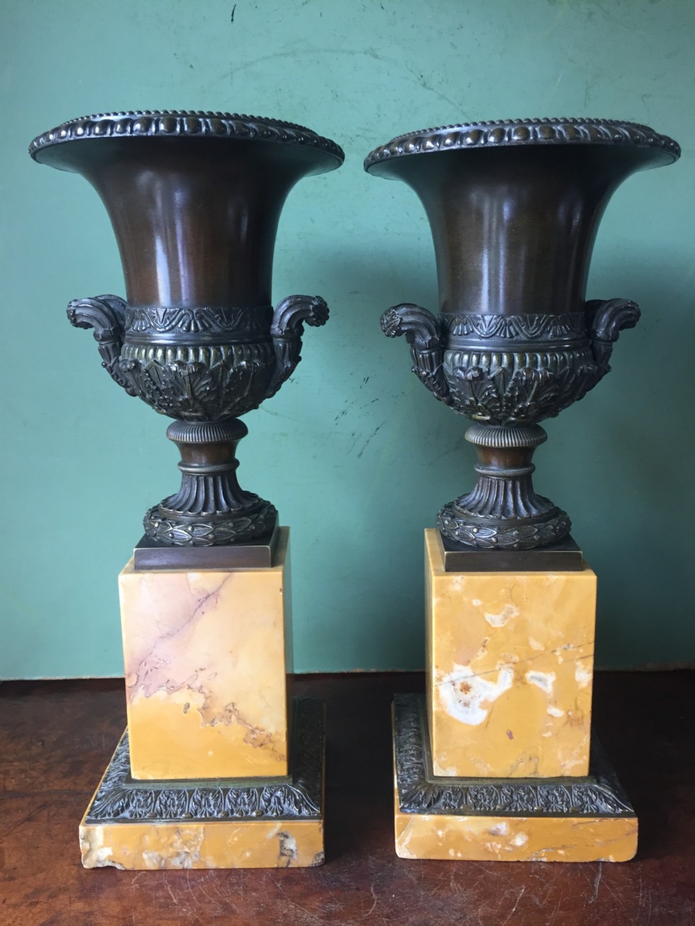 Pair of French early C19th Charles X period bronze campana shaped urns on siena marble plinth bases. View II