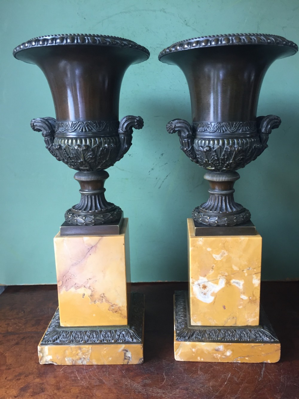 Pair of French early C19th Charles X period bronze campana shaped urns on siena marble plinth bases. View IV