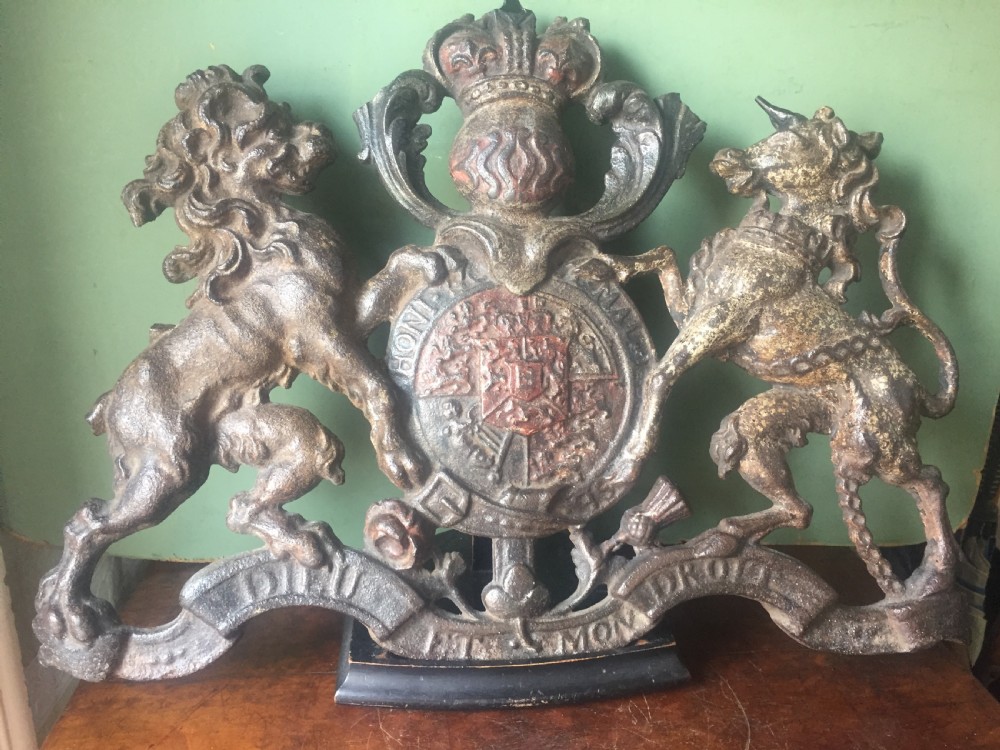 Mid C19th British cast-iron 'coat of arms' or Royal cypher with traces of original polychrome painted decoration.